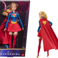 Barbie Signature DC Supergirl Fashion Doll, Blonde with Super Hero Costume & Cape, Collector Doll in Displayable Packaging & Doll Stand