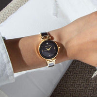 Reloj de pulsera Anne Klein con esfera de diamantes genuinos y diseño elegante en negro y dorado