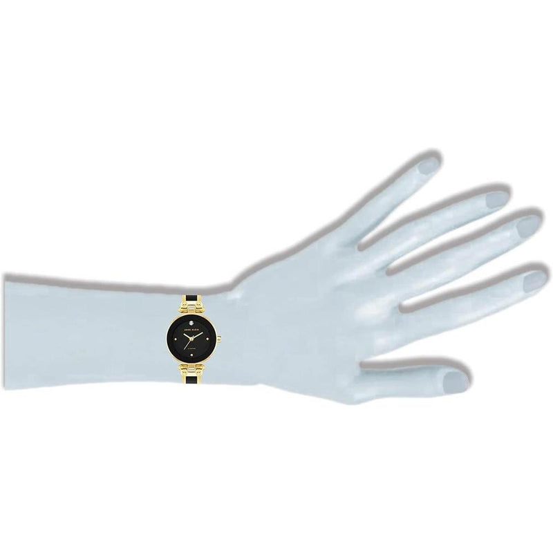 Reloj de pulsera Anne Klein con esfera de diamantes genuinos y diseño elegante en negro y dorado