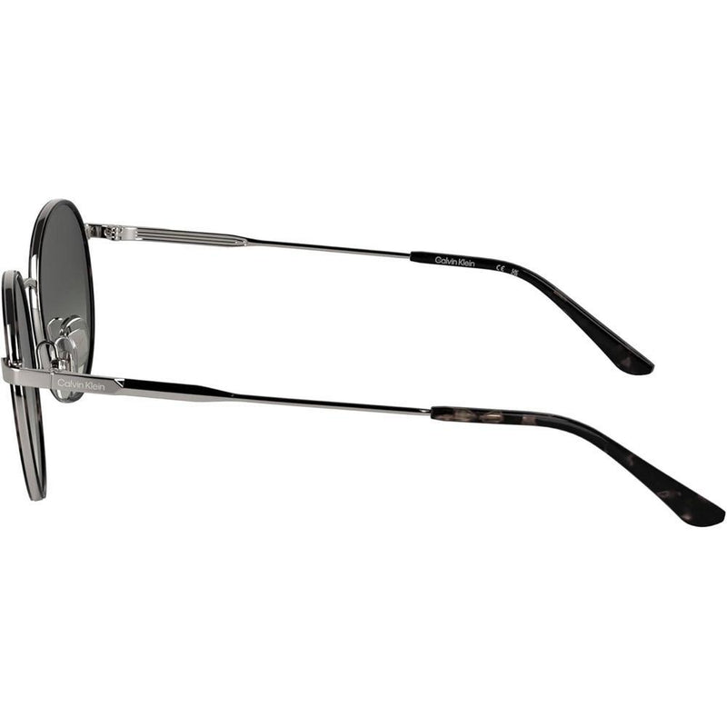 Lentes de sol Calvin Klein CK25101S con diseño redondo y marco de metal, incluyendo almohadillas nasales ajustables para mayor comodidad