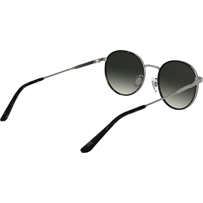 Lentes de sol Calvin Klein CK25101S con diseño redondo y marco de metal, incluyendo almohadillas nasales ajustables para mayor comodidad