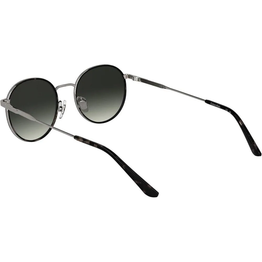 Lentes de sol Calvin Klein CK25101S con diseño redondo y marco de metal, incluyendo almohadillas nasales ajustables para mayor comodidad